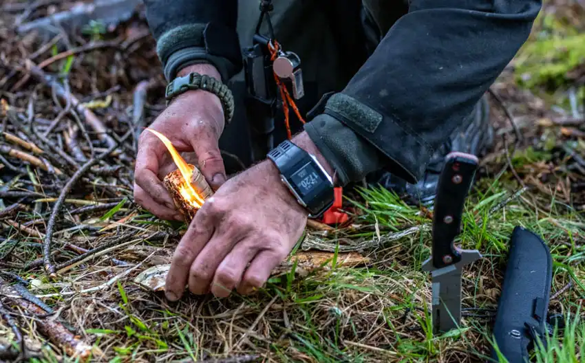 A man trying to build a campfire using fire starter
