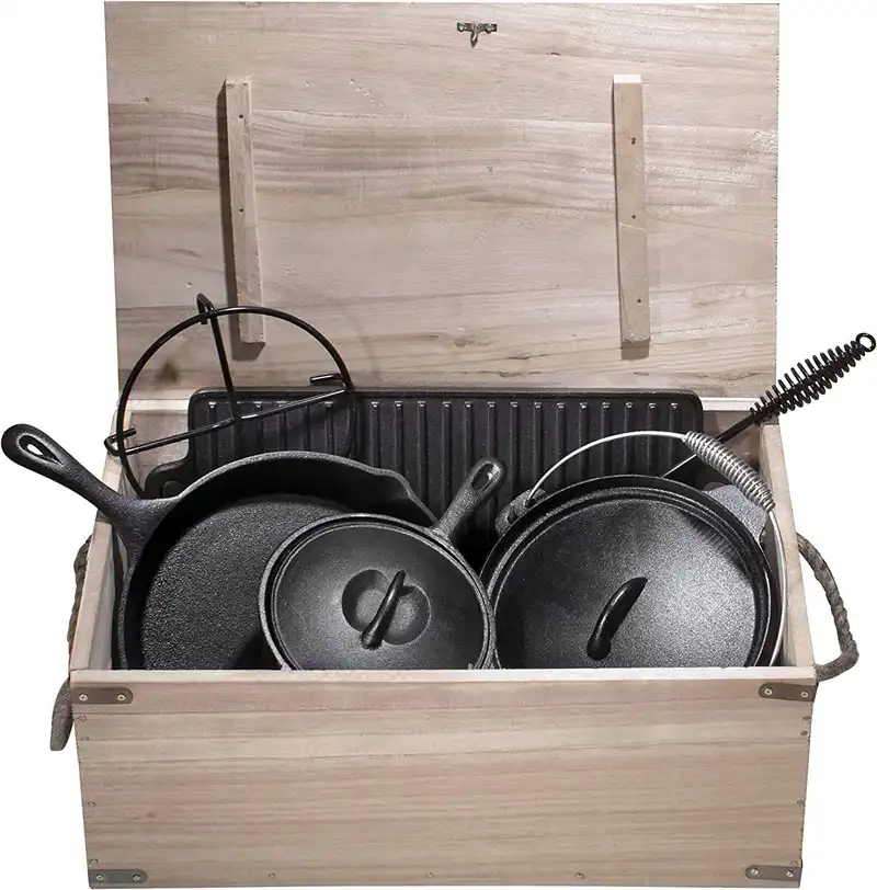 wood box with pots and pans, campfire grill with a few accessories