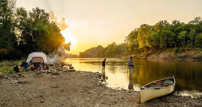 Campers fishing in lake during sunset in the USA, Missouri, St. Louis